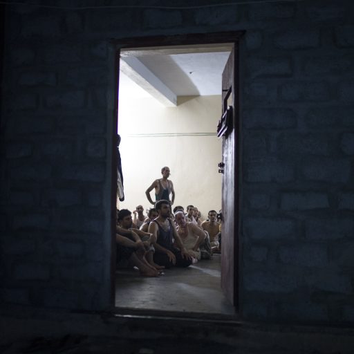 Four hundred and seventeen detainees gather in a small hot room, 300 of which have proven to joining ISIS, in Fallujah with Al Saqlawiya in Anbar, Iraq on June 3, 2016. When IDPs arrive at military camps, it is difficult for the government to know who might be an ISIS sympathizer and/or someone who is trying to get behind enemy lines. Many hundreds, if not thousands, of men have been sent to detention centers until it can be verified that they are not indeed ISIS sympathizers. At the time of these photographs, this region of Iraq was at the front line between Iraqi government forces and ISIS. Thousands of civilians were forced to flee from their homes to avoid being trapped.