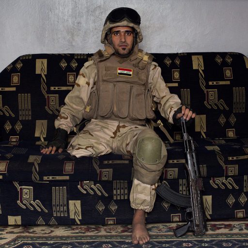 Hussein sits on his couch in his army uniform in Baghdad, Iraq on April 4, 2012. 

On January 22nd, 2012, an IED (Improvised Explosive Devise) detonated near an Iraqi Army base in Fallujah. Hussein Jamil Abdullah, a 28 year-old soldier from Baghdad was nearby when the explosive discharged, knocking him to the ground. Hey lay there for half an hour, his right leg in an jerry-rigged tourniquet made from a headscarf, before he was taken to hospital.

Gangrene set in almost immediately and the doctors at Fallujah General Hospital had to amputate his leg. He was then moved to Adnan Military Hospital, but the care Hussein received was terrible. His bandage wasn' t changed for two days and fearing that gangrene would set in a second time his family moved him to Kerkh Hospital where they had to cover the costs themselves, as the army refused to pay.

As soon as he was wounded, the Iraqi Army cut Hussein s salary in half: from $500 a month to $250, which is less than he can live on. His brother, Ali, gave up his work as a barber to take care of him, and his two other brothers, Abbas and Hassan, started taking care of the family.

Before he was wounded, Hussein had bought and furnished a room in preparation for his wedding to was to his fiancée, Hind, but after the explosion, Hind 's father refused to allow them to marry, claiming that Hussein wouldn’t be able to take care of her.

In the summer, a selection of photographs were published online and caught the attention of an NGO worker in Baghdad who arranged for Hussein to have a prosthetic leg fitted.

Once he had his prosthetic leg, Hussein married Hind.

Photo by Ali Arkady