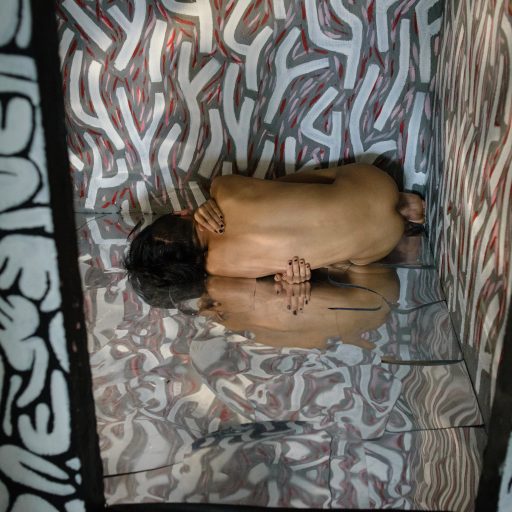 Gypsy, a young artist, poses nude in a room turned into an art installation in his apartment in the suburb of Shanghai. Shanghai, China, 2018. ©Oleksandr Rupeta for the VII Mentor Program.
