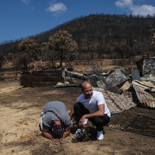 In Alexandroupolis, Greece, on Sept. 8, 2023, Syrian refugee Qusai Alahmad, 31, is comforted by his cousin Abdulrahman Alahmad at the location where his brother Basel and 17 other migrants died in wildfires near the northern Greek village of Avantas. ©Byron Smith for VII Mentor Program.
