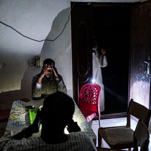 The Akasha family sits in the dark amid a power outage in Khartoum, Sudan, on Dec. 14, 2020. ©Byron Smith for VII Mentor Program.