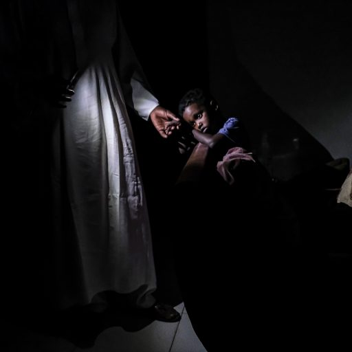 In Khartoum, Sudan, on Dec. 14, 2020, 3-year-old Muhaned Akasha and his family sit in darkness during a power outage. ©Byron Smith for VII Mentor Program.