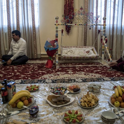 until 7 June 2018] On 30 March 2018 in Turkmenistan, Mekan, 33 (father); Menzil, 31 (mother); Mengli, their third child and first girl, born 27 March (baby girl); Sulgun, 83 (great grandmother) at home in Goekdepe. 

Four generations live in Menzil’s family home including his 83 year old grandmother and his newborn son, now just three days old. “My eldest son is about to go to school. I always help him learn. He loves sport, gymnastics. Soon I will enrol them in Russian and English classes,” said Menzil. “I was away when my wife went into labour, otherwise I would’ve been in the waiting area. On the day of the birth, I came to my wife in the hospital and took the day off work. I had to go back to work today though, so I could not drive the car home myself, but it was still decorated.” © Adriana Zehbrauskas for UNICEF.
