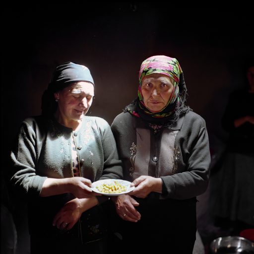 Sisters boiling chickpeas for Tikya Bozbash, a meal of mutton, potatos and vegetables cooked in a broth to be served for the wedding guests. Xinaliq village. July 2009. © Rena Effendi.