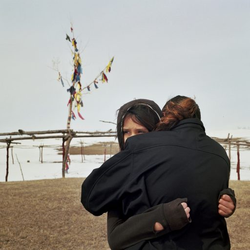 Shauncina Lovejoy, age 12 hugging her aunt Jada Longie 39 y.o. near the Crow Hill Sun Dance grounds. "I can take you in, my girl..." - Jada says to Shauncina. Spirit Lake, North Dakota. April, 2013. © Rena Effendi.