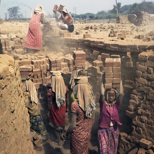 Where Gandhi once walked on his famous Salt March to protest British rule, tribal women in Kapletha are still weighed down by poverty. At a brick kiln they earn less than three dollars a day. Gujarat, India. March 2013. © Rena Effendi.