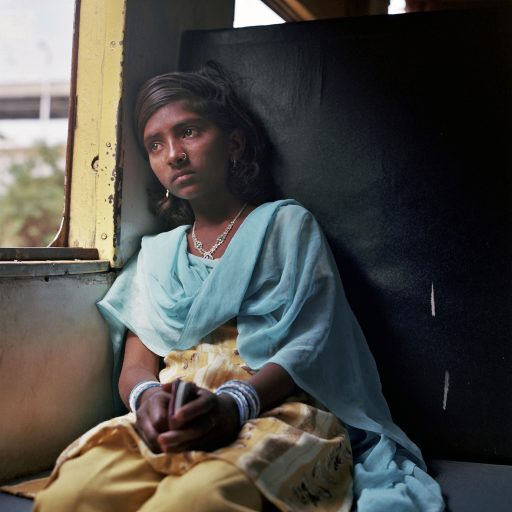 Gandhi discovered the soul of India by traveling on trains in low-cast compartments. This is where he came face to face with the country’s social divide. Payal (12 y.o.) is from untouchable family, she and her father boarded this Pratap Nagar narrow gauge inter-city train terminating in Jambusar. The latter stages of this train’s itinerary pass along the Salt Marsh route. March, 2013, Padra, Gujarat, India. © Rena Effendi.