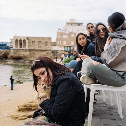 In Batroun people sit on the seaside near the Phoenician ruins. March 7, 2021. Lebanon. © Rena Effendi.