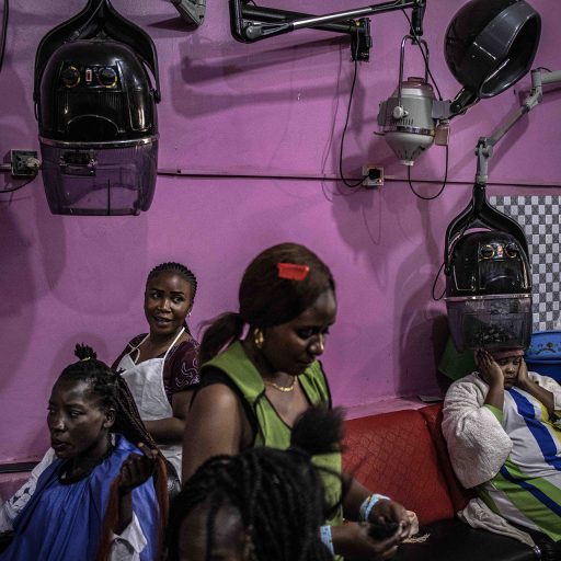 Customers have their hair done at a salon in the city of Bunia in eastern Democratic Republic of Congo, May 16, 2021. Bunia is located in Congo's Ituri province, which was put under a state of siege this month by the government, which is trying to contain a wave of violence by armed militias in the region. © Finbarr O’Reilly for Fondation Carmignac.