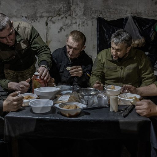 Members of a Ukrainian tank crew from the 42nd Brigade eat lunch in a bunker on the frontline in Ukraine’s eastern Donetsk region, December 30, 2023. © Finbarr O’Reilly.