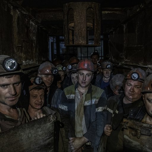 Miners enter an elevator shaft at the start of a 6-hour shift at 1/3 Novogrodivska state-run coal mine, near the town of Selidove, in Ukraine’s eastern Donetsk region, June 8, 2022.  © Finbarr O’Reilly.