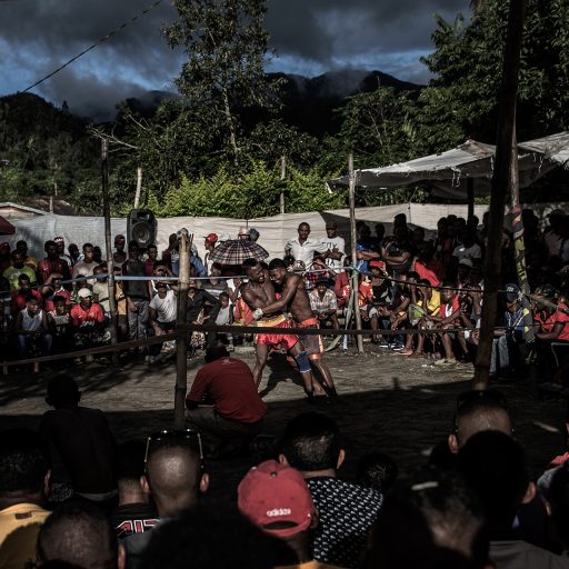 Spectators watch fighters during a tournament of traditional Moraingy bare-knuckle fighting in Andapa in Madagascar's northeastern Sava region. © Finbarr O’Reilly.
