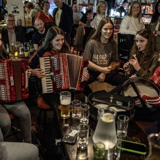 Teenagers perform during a night of traditional music at the The Fleet Inn at Irish fishing port of Killlybegs, April 6, 2023.  © Finbarr O’Reilly.