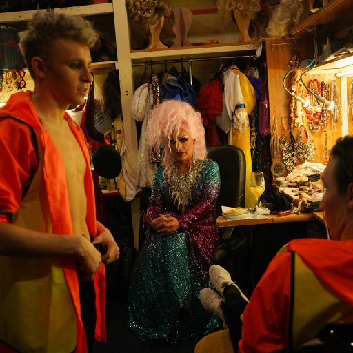 A group of drag artists prepares in a dressing room for a performance in a cabaret in Saint Petersburg. In this cabaret, the atmosphere is one of camaraderie and support, laid-back with chats and jokes all around. A cabaret with a drag show is a lively and entertaining performance venue that features drag artists performing a variety of acts, including lip-syncing, dancing, and comedy routines. The atmosphere is usually filled with energy as the performers interact with the audience, creating a sense of community and acceptance. The shows often incorporate elaborate costumes, makeup, and humorous banter.

In the end of 2023, the Supreme Court of Russia recognized the "international public LGBT movement" as extremist. ©Mary Gelman.