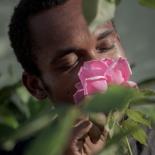 In April 2022, Gabriel Pataxó smells one of the roses planted in the garden of his house in the city of Carmésia, state of Minas Gerais, Brazil. Gabriel recently moved from the state of Bahia in the northern part of the country after facing interpersonal issues in one of the villages in the region. The city of Carmésia serves as a retreat for some members of the Pataxó ethnicity, as it provides them with greater contact with their native culture and traditions. © Leonardo Carrato.