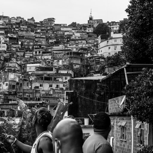 On April 17, 2020, during the Covid-19 pandemic, a group of favela residents gather to fly kites on one of the community's thousands of rooftops. This activity becomes one of the only forms of leisure for that group during times of social isolation. © Leonardo Carrato.