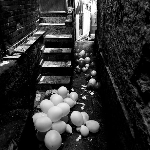 On May 8th, 2020, balloons from a party were left on the narrow alleys in Favela da Rocinha, Rio de Janeiro. Favelas are known for their cultural activity. The housing issue forces numerous families to share a small space, making social isolation practically impossible. Small celebrations are still happening as a way of avoiding the harsh reality. © Leonardo Carrato.