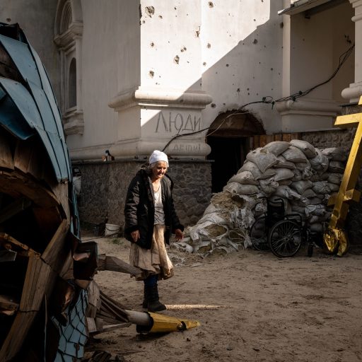 A resident taking shelter at the severely damaged Zymnensky Female Monastery walked through the courtyard, as seen in Sviatohirsk, Ukraine, on Monday, October 3, 2022. Part of Sviatohirsk was occupied by Russian forces until September 12, when the Ukrainian military recaptured the town. © Nicole Tung.