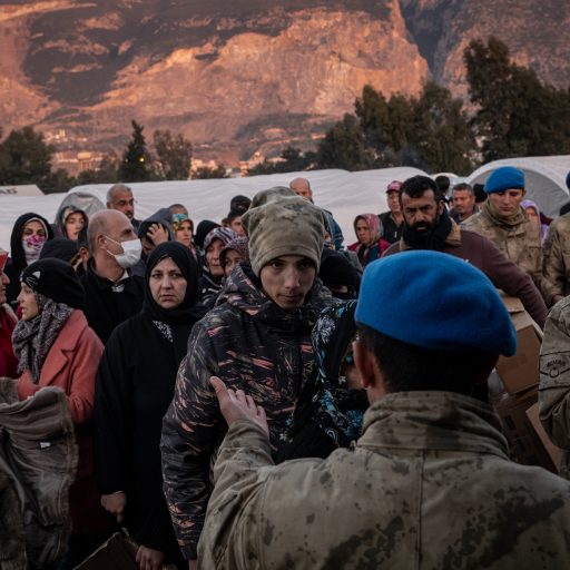 Displaced residents, taking shelter in a tent camp, lined up for a clothing and other aid during a distribution in Iskenderun, Turkey, on Tuesday, February 14, 2023. 

More than 31,000 people have died and an estimated 200,000 people have been evacuated to nearby provinces, according to official numbers, following two major earthquakes last week in Turkey’s south and south east. © Nicole Tung.