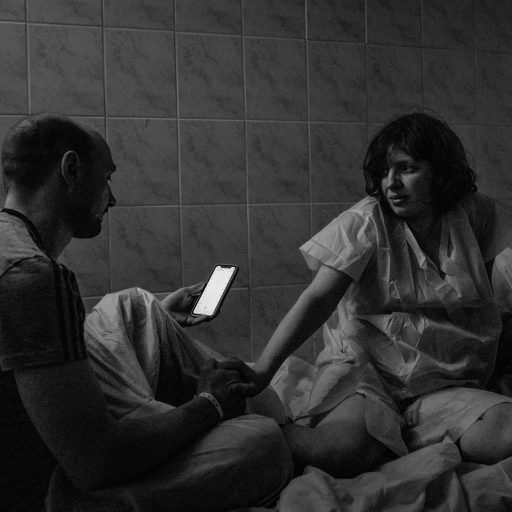 Ana and her husband Yuri measure the time between her contractions as Ana goes into labor at a maternity hospital’s makeshift bunker in Kyiv, Ukraine, on Wednesday, March 2, 2022. Expectant and new mothers have been moved underground to protect them from Russian attacks and fighting that have struck the city in recent days.

The war has expanded in recent days as the Russian military advanced into towns in the Kyiv Oblast region, north west of Kyiv city as it edges its way towards the capital, as well as larger cities including Kharkiv, Kherson, and Mariupol’. 

Russia launched a full scale military invasion of its neighboring country Ukraine, on February 24, triggering a mass exodus of over one million citizens and residents across multiple borders, and sending civilians underground into shelters. The casualties are mounting with no signs of an end to this war. © Nicole Tung.