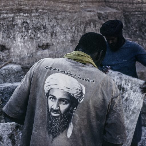 Mali, 2009. Agorgot salt mine, Taoudenni, where men work for a period of six months. The bin Laden t-shirt showcases the influence of AQIM (Al-Qaeda in the Islamic Maghreb) in the region. © Pascal Maitre.
