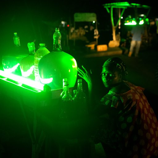 Benin, Porto-Novo. Women are selling petrol smuggled from Nigeria by the roadside. The fuel is used to operate generators and vehicles. © Pascal Maitre.
