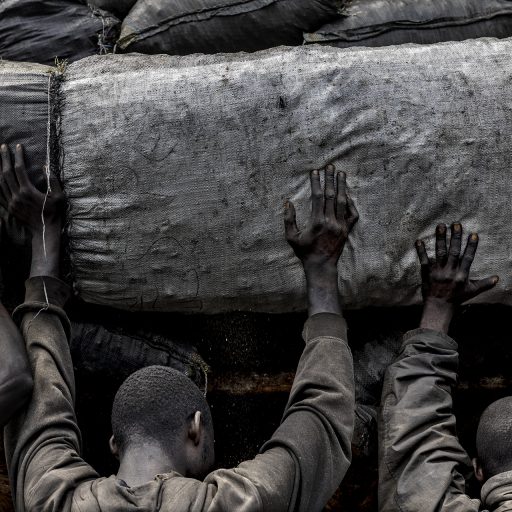 RD Congo 2021, at Mbankara in the Kwango region, a large charcoal depot, these trucks filled with bags of charcoal will be delivered to Kinshasa. Charcoal mining is a mammoth task. © Pascal Maitre.