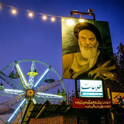 Iran, 1985. Eran amusement park in Tehran where people can enjoy rides on public holidays, under the gaze of Ayatollah Khomeini. © Pascal Maitre.