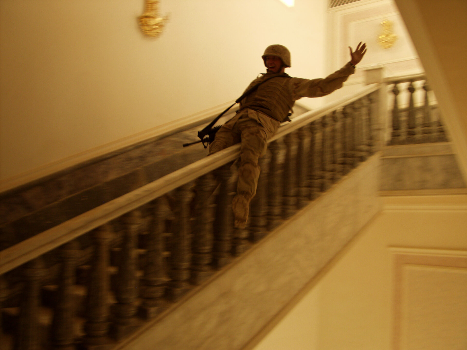 A U.S. Marine slides down the marble bannister in Saddam's palace in Tikrit, Iraq, April 14, 2003. Tikrit was the last major city in Iraq to fall, and many people felt it symbolized the end of the fighting in Iraq.
The palace is not only enormous, but contains decor worth hundreds of thousands of dollars. A river was re-routed to pass the palace amongst many other examples of the Hussein familie's wealth. © Ashley Gilbertson / VII.