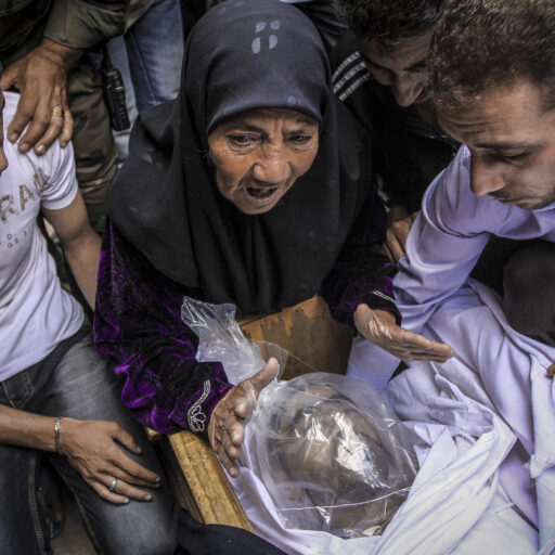 The mother of Ahmed, a Syrian soldier killed in fighting, mourns over his body during his funeral in rural Damascus, Syria. © Ali Khara.