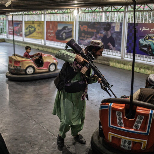Taliban soldiers ride bumper cars at an amusement park in Kabul, Afghanistan. © Ali Khara.