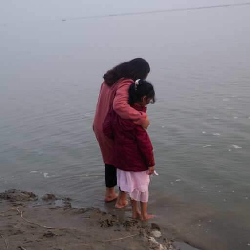 Sanjida Islam Tulee, coordinator of Maayer Daak (Mothers’ Call), stands by the banks of the Padma River with Fawzia Muskan.
Fawzia is the eight-year-old daughter of Md. Murshidul Islam, disappeared on 19 April 2017. Tulee’s brother, Sajedul Islam Suman, also disappeared on 4 December 2013 along with seven others.
Maayer Daak is an organisation of the families of the disappeared, where survivors sustain one another with courage and collective resistance.This photo was taken on December 21,2024. © Mosfiqur Rahman Johan.