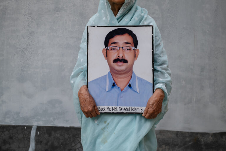 Hazera Khatun, founder of Maayer Daak, holds a photograph of her missing son, Sajedul Islam Sumon, in this image taken on February 12, 2025. Sumon, a leader of the Bangladesh Nationalist Party, was allegedly abducted by members of the Rapid Action Battalion in Dhaka in 2013 and has remained missing since. © Mosfiqur Rahman Johan.