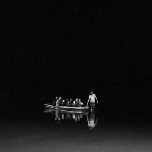 A raft of America-bound migrants floats in darkness in the middle of the Rio Grande River in Roma, Texas. © Svet Jacqueline.