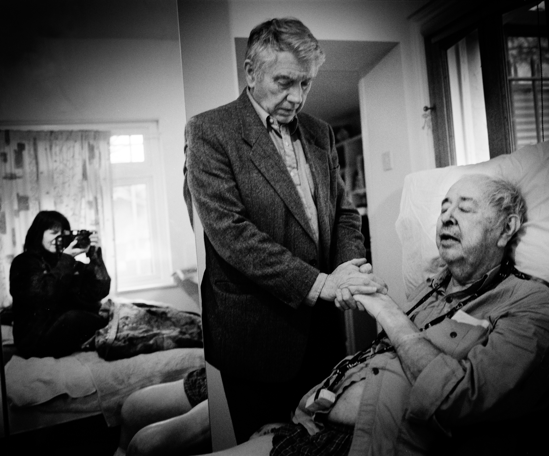 Self Portrait with Philip Jones Griffiths on the day he died and his friend Don McCullin 2008. © Donna Ferrato.