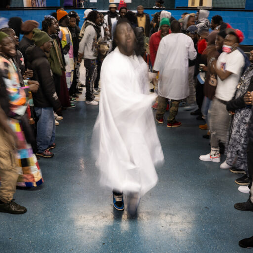 Harlem, Manhattan — Senegalese men who identify as Baye Fall, a subgroup of the Mouride Sufi brotherhood centered in Touba, Senegal, sing and drum the Sufi chant “Sam Fall” (CQ) during Dundal Koor (CQ) , a religious festival marking the 20th day of Ramadan, at the Presbyterian Church of Ghana in Harlem on Sunday, April 13, 2025. The large gathering, known as a Magal (festival), is part of their devotional practice honoring Allah and the teachings of Cheikh Ahmadou Bamba, the founder of the Mouride brotherhood. © Arisa Haboshi.