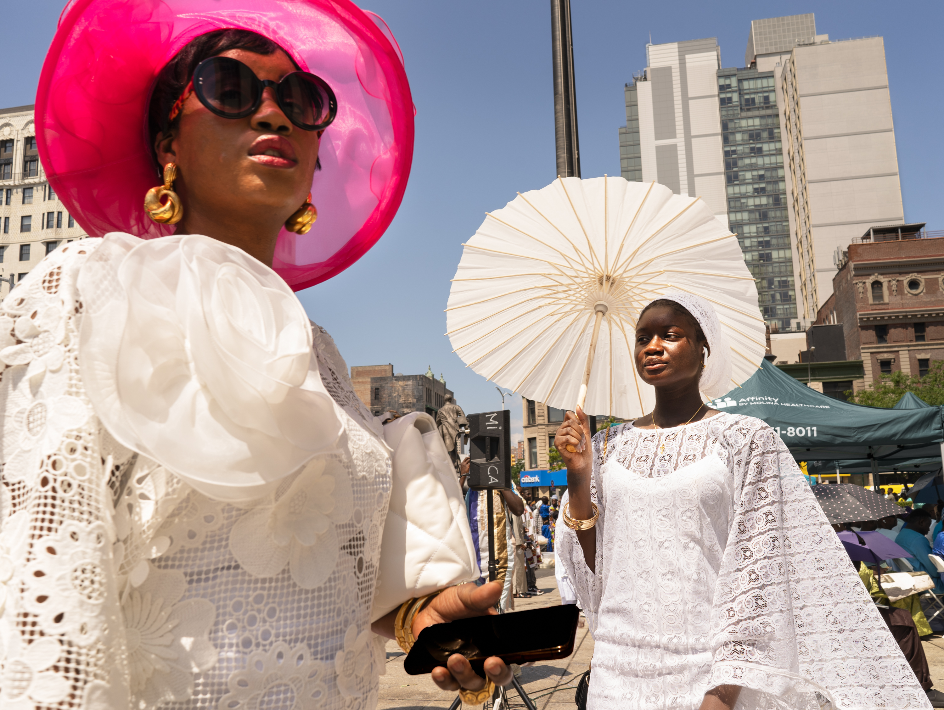 Harlem, Manhattan — Participants in the Cheikh Ahmadou Bamba Day march walk in front of the Adam Clayton Powell Jr. State Office Building in Harlem on Tuesday, July 28, 2026. Hundreds of members of the Mouride Sufi brotherhood from across the United States and Senegal take part in the annual observance, which commemorates Cheikh Ahmadou Bamba, the founder of Mouridism; David Dinkins, then Manhattan borough president, issued the decree recognizing Cheikh Ahmadou Bamba Day in 1988. © Arisa Haboshi.