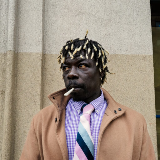A Senegalese street vendor rests in the Bronx, New York, after buying ingredients for food he planned to sell on Canal Street on Tuesday, October 28, 2025. While shopping, he receives a phone call from another Senegalese vendor reporting that ICE agents have been seen again on Canal Street, prompting him to cancel the day’s sales despite already purchasing the ingredients. © Arisa Haboshi.