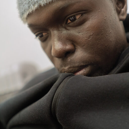 Bronx, New York — A Senegalese immigrant who asks not to be identified sits inside an apartment he shares with six other Senegalese men in the Bronx on Sunday, February 2, 2025. © Arisa Haboshi.