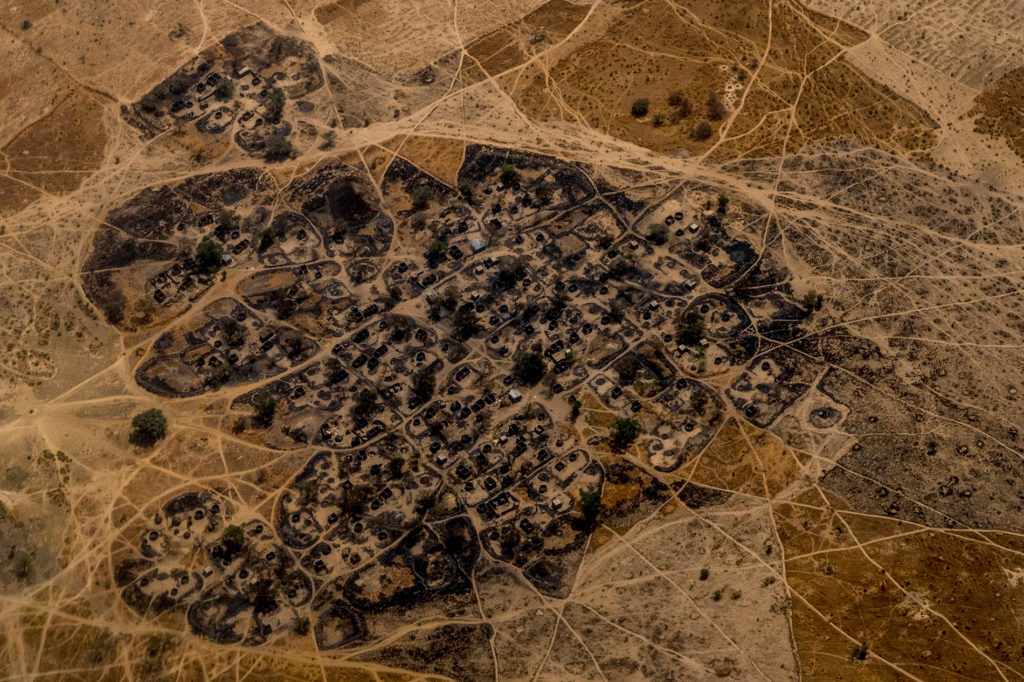 A burned Nigerian village seen from a United Nations helicopter flying between Maiduguri and Monguno. Villages have been razed and burned by both Boko Haram and the Nigerian Military throughout the region. PHOTO BY ASHLEY GILBERTSON / VII.