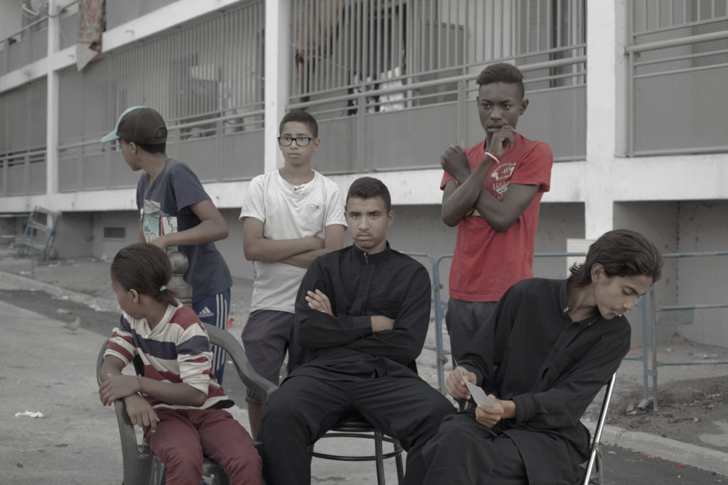 A group of young men hang out on the streets of their neighborhood Felix Pyat in the northern district of Marseille or "Quartier Nord". The "Quartier Nord" is on the spotlight for being one of the poorest areas of Marseille and by having high crime rates. Marseille, France. Arnau Bach