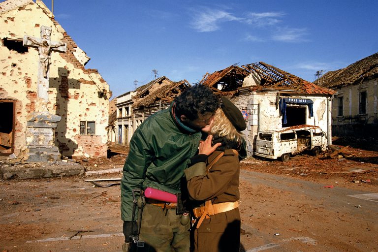 A Serbian couple kisses after the fall of Vukovar, Fall 1991. © Ron Haviv / VII Photo